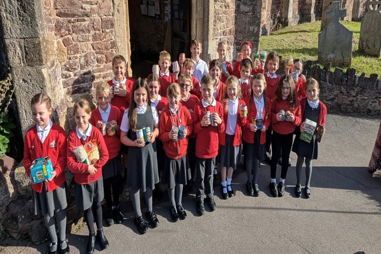 Dunster First School pupils marking harvest festival at the village's Priory Church of St George.