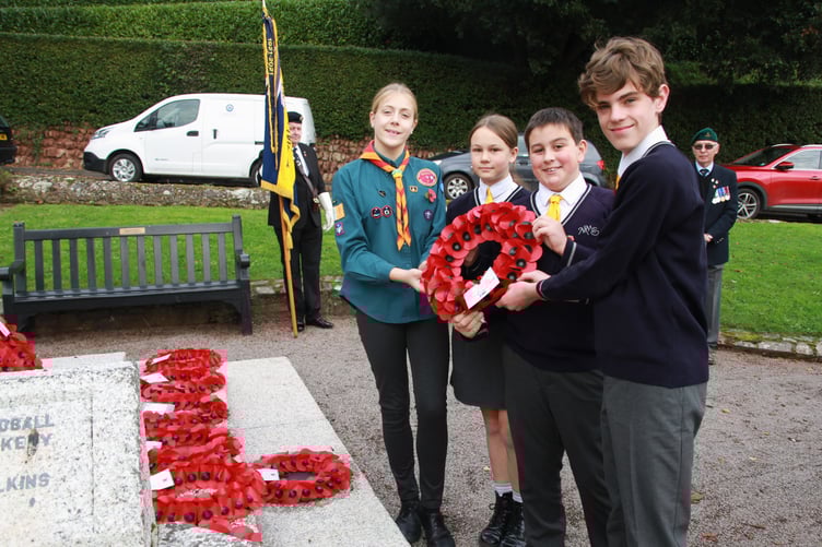 Minehead Middle School pupils Polly Pyburn, Tom Ellicott, Isobel Sheasby, and Ben Cobb lay a wreath at the war memorial on North Hill on Armistice Day. PHOTO: George Ody.