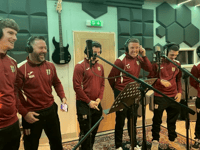 Football players hoping to score with Christmas song