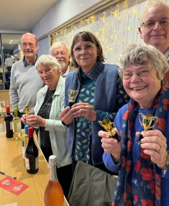 Winning quiz team, the Optimists, with their prizes and trophies