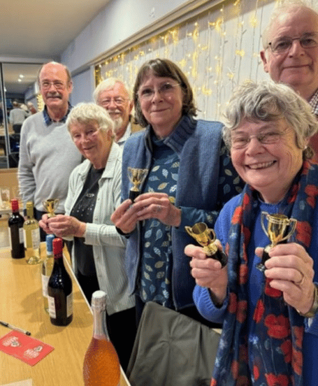 Winning quiz team, the Optimists, with their prizes and trophies