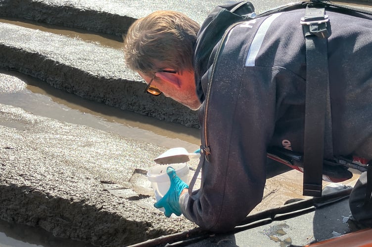 An Environment Agency officer carries out water sampling at a beach. PHOTO: EA.