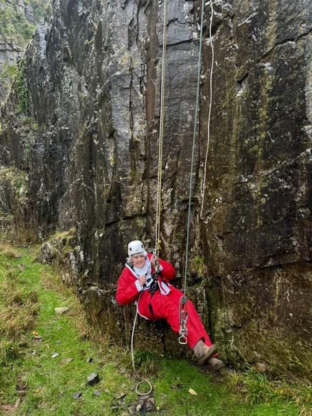Watchet's Sam Westmacott completes her Santa abseil in Cheddar Gorge for St Margaret's Hospice.
