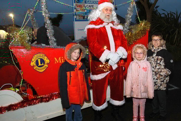Father Christmas met Theo Sims Taylor, Tegan Sims Taylor and Chester Sims Taylor when he visited Minehead for a Victorian-themed extravaganza. PHOTO: George Ody.
