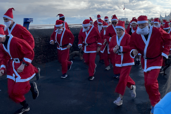 Santas set off on a Minehead sea front charity fun run hosted by the local Rotary.