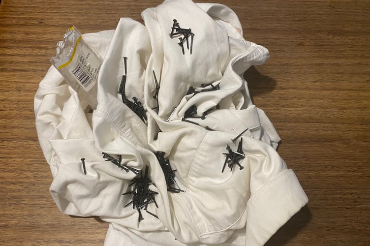 'Tax in Creases, winnder of the Turnip Prize. 'Photo released December 4 2024. This year's winner for the fake art award the 'Turnip Prize' has been revealed - a crumpled white shirt with tacks sprinkled into the creases.The annual contest is a spoof of the 'Turner Prize' and awarded to the person who has created crap art - using the least amount of effort possible. At a ceremony held at The New Inn, Wedmore, Somerset, 'Wonga Woman', 39, was awarded first prize for her work entitled Tax in Creases - a crumpled white shirt with tacks sprinkled into the creases.The award was made in front of a 'packed art-loving audience' who cheered when the winner accepted the prize: a turnip mounted on a six-inch nail.