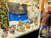 Charity shop window funfair stops passers-by