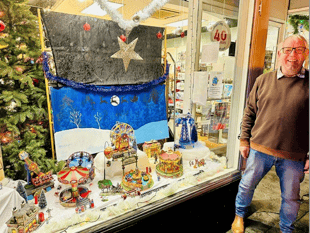 Charity shop window funfair stops passers-by
