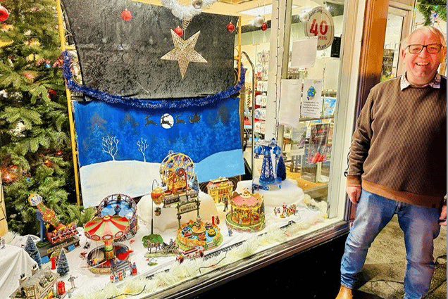 Brian Giles with the working funfair model he has created in the window of St Margaret's Hospice shop in Friday Street, Minehead, which costs £1 a go.