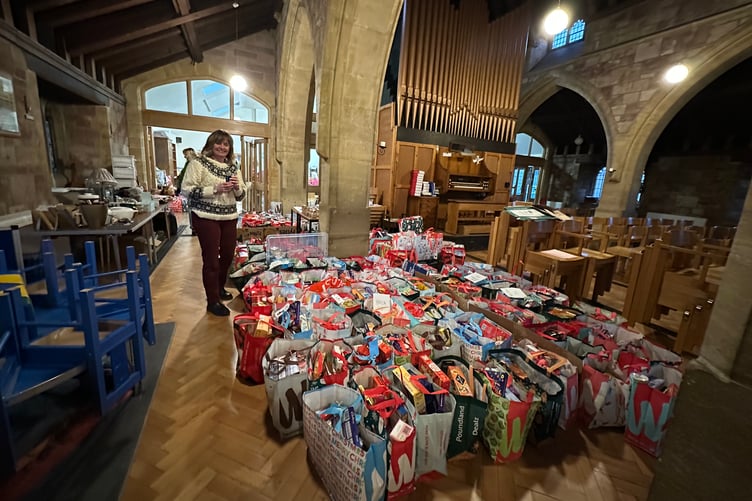 West Somerset Food Cupboard team leader Sara Trigg with Christmas food bags awaiting collection. PHOTO: WSFC.
