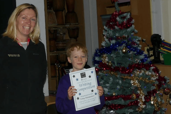 Finley Richardson, pictured with Exmoor National Park Authority rural enterprise co-ordinator Julie Colman, won a special prize in the Exmoor Dark Skies Festival children's writing competition. PHOTO: ENPA.