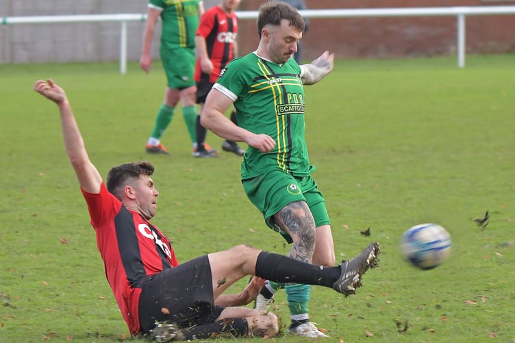 Kieran Bailey (red & black) in action for Watchet Town
