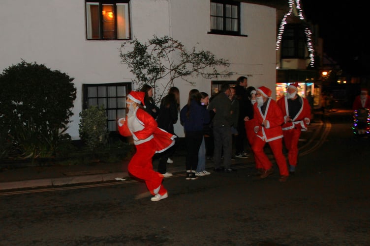 Competitors in Porlock's annual 'Santa Dash' through the village during the late night shopping experience. PHOTO: George Ody.