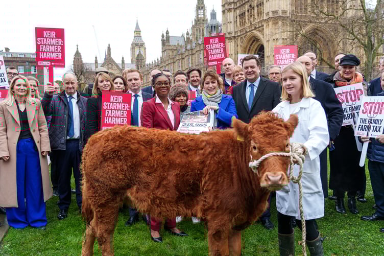 Conservative Party leader Kemi Badenoch and Shadow Defra Secretary Victoria Atkins pictured with supporters and Vicky the calf presenting a petition to Government co-started by Exmoor farmer James Wright.