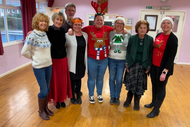 Re-Engage West Somerset co-ordinator Renata Urkay (right) with some of the volunteers and guests at the charity's Christmas party.