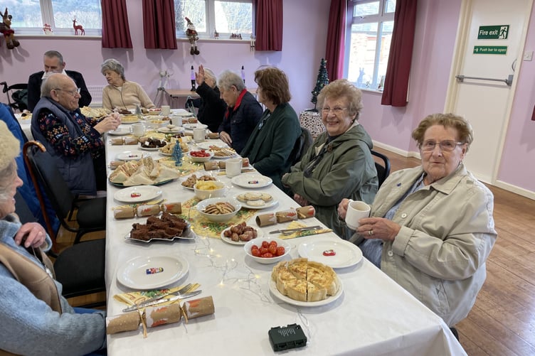 Guests attend a Re-Engage Christmas party in Timberscombe Village Hall.