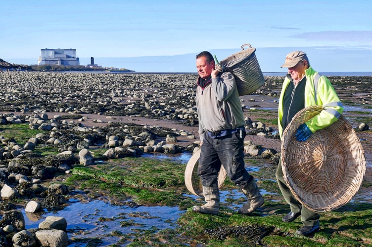 Adrian Sellick and his late father Brendan out on the estuary with Hinkley Point in the background. PHOTO: Martin Hesp.