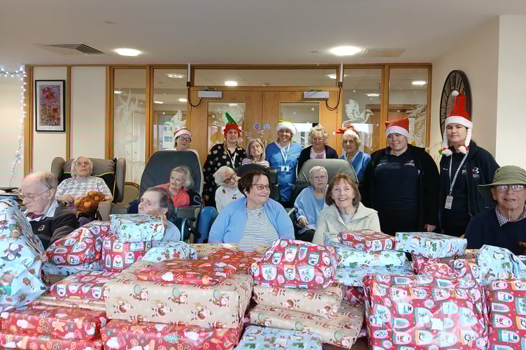 Some the Somerset Care Group residents and colleagues with Christmas donations for local food banks to gift to struggling families.