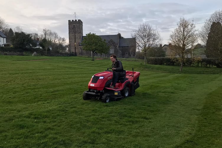 The George Meadow Millennium Green being mowed in Brompton Regis.
