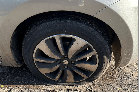 One of the punctured tyres on the vandalised Suzuki car in Watchet.