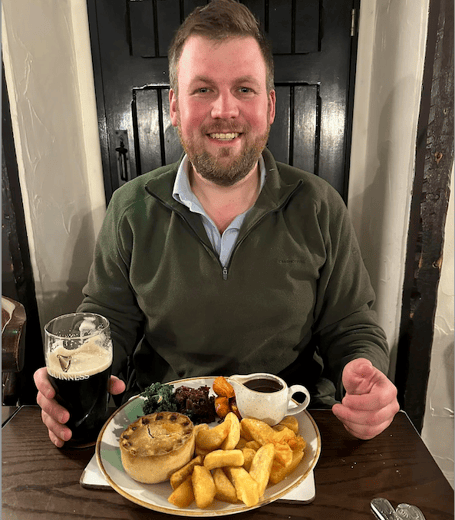 Exmoor campaigner James Wright with a pint and a pub meal in the Royal Oak, Winsford.