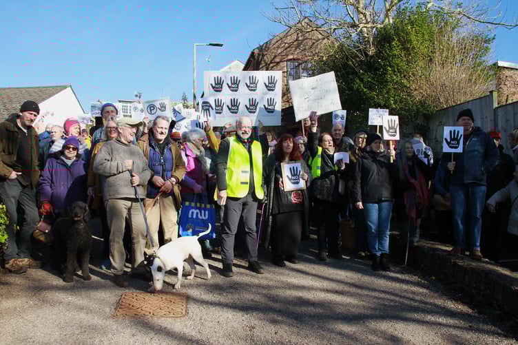Cllr Dave Mansell pictured at the head of a large protest in Wiveliscombe against proposals to stop free car parking. PHOTO: George Ody.