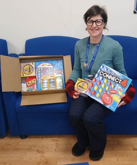 Minehead Middle School librarian Ellen Vickery with new games for the school's boardgames club.