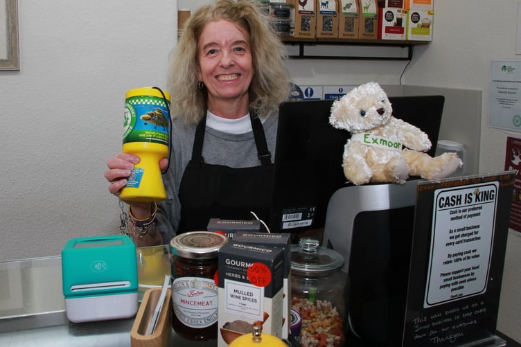 Karen Bennett behind the counter of Exmoor Del, Dulverton, with the new air ambulance collecting pot. PHOTO: George Ody.