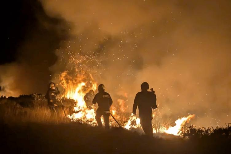 Firefighters tackle an 80-acre fire on the edge of Exmoor at West Anstey Common. PHOTO: DSFR.