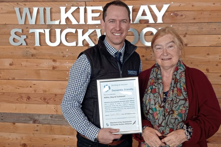 Wilkie May and Tuckwood’s Justin Harris receives the company’s Watchet dementia alliance membership certificate from Margaret Tatham.