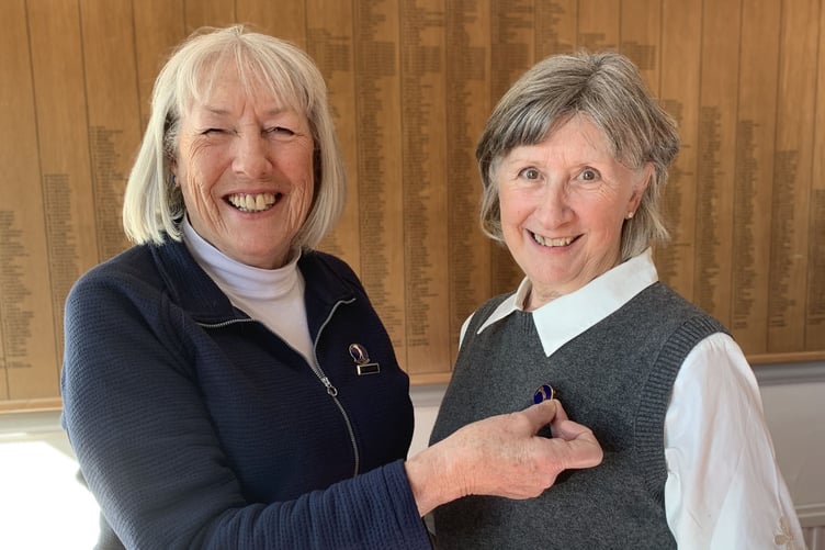 Outgoing captain Ginnette Bowyer presenting incoming captain Pat Lucas with the captain’s brooch.