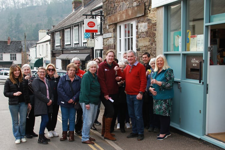 Retiring Dulverton Postmaster Chris Duberry hands over his keys to Melanie Poole. PHOTO: George Ody.