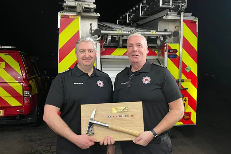 Devon and Somerset Chief Fire Officer Gavin Ellis (left) makes a retirement presentation to Nether Stowey watch manager Nick Rich. PHOTO: DSFR.