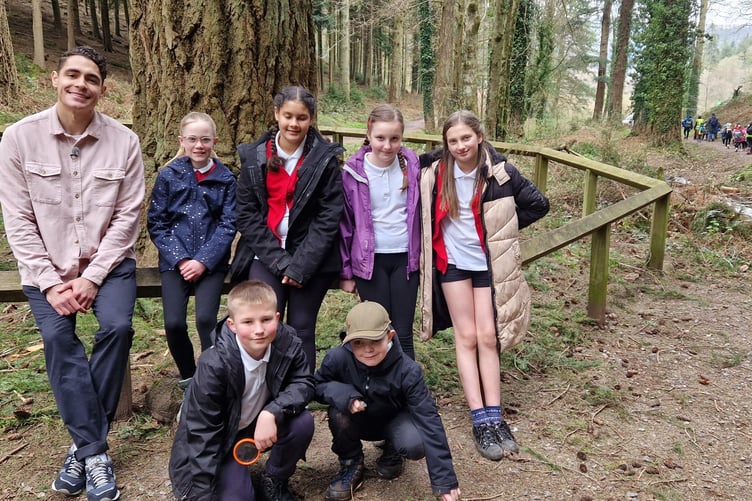 Some of the year six pupils with BBC Newsround presenter Otis Holmes, who filmed their day at Nutcombe Bottom. PHOTO: Forestry England/Crown copyright.