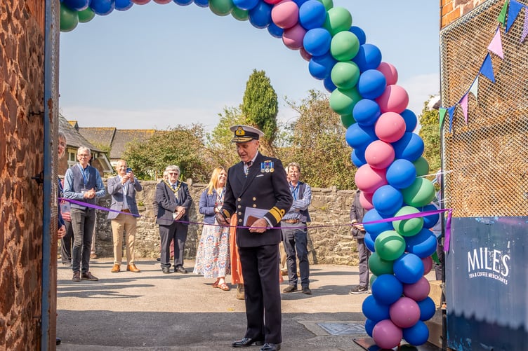 Deputy Lord Lieutenant of Somerset Ian Moncrieff cuts a ribbon to open Porlock's Vale Yard. PHOTO: Shaun Davey.