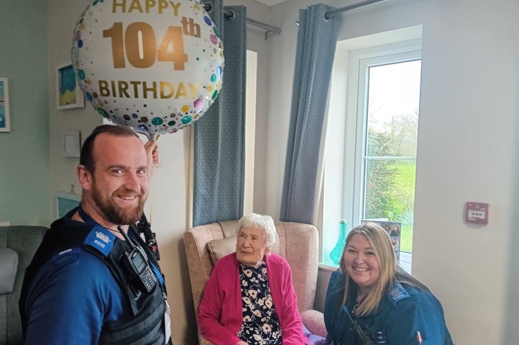 Watchet and Williton PCSOs Zak Howe and Katherine Williams surprised Connie Matthews on her 104th birthday in Croft House, Williton, with a present and card from their Chief Constable.