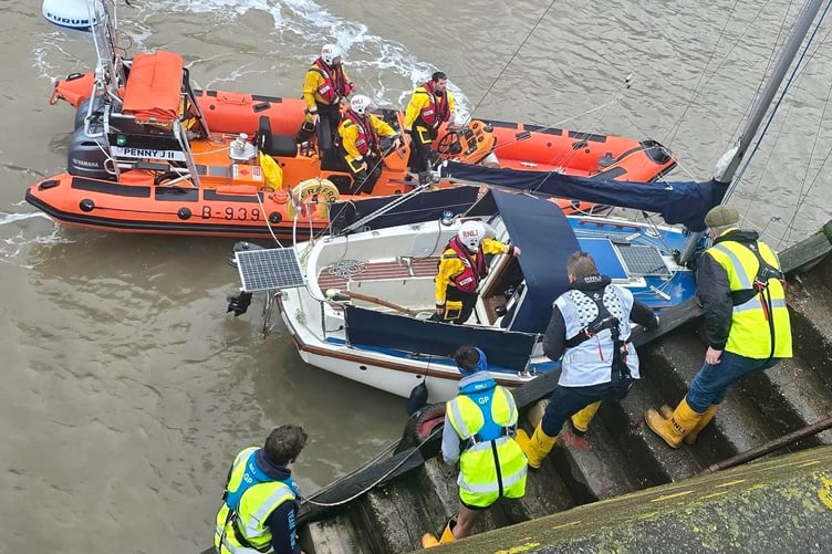 Lifeboat volunteers help moor a rescued yacht in Minehead Harbour on Good Friday. PHOTO: Macauley Hughes.