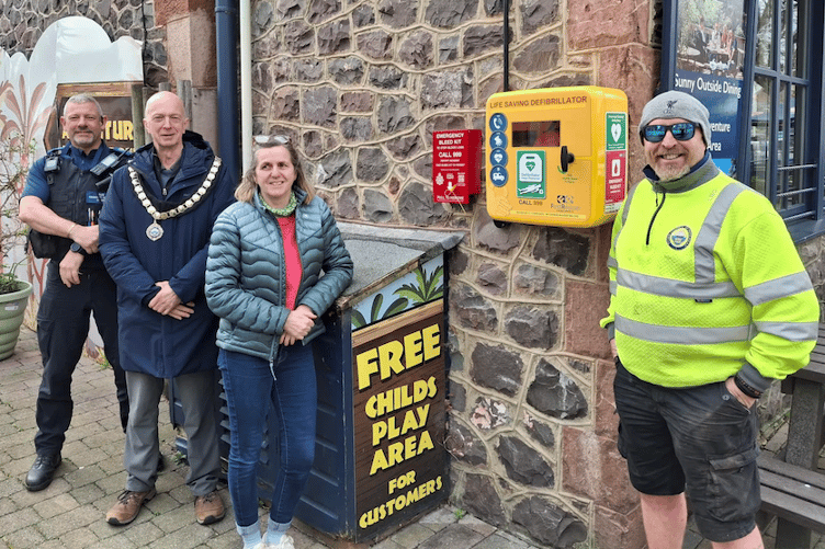 PCSO Mark Middleton-Smith and Minehead Mayor Cllr Craig Palmer attend the installation of a bleed kit outside the town's Hairy Dog public house. PHOTO: MTC.