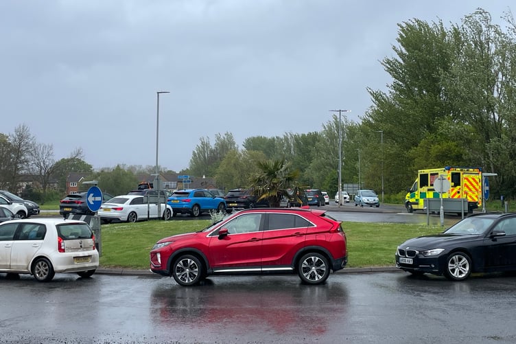 An ambulance responding to an emergency call has to drive the wrong way around the A39 Ellicombe roundabout on a recent weekend to negotiate traffic congestion blocking the road.