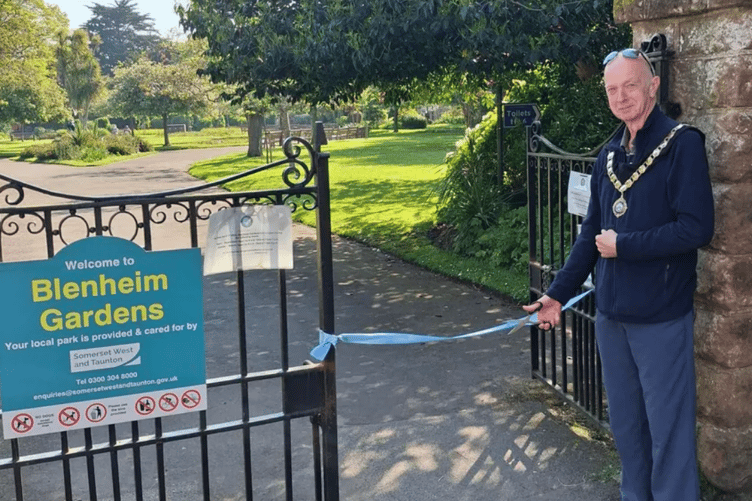 Minehead Mayor Cllr Craig Palmer cuts a ribbon to mark the town council taking ownership of Blenheim Gardens and other open spaces in the town. PHOTO: MTC.