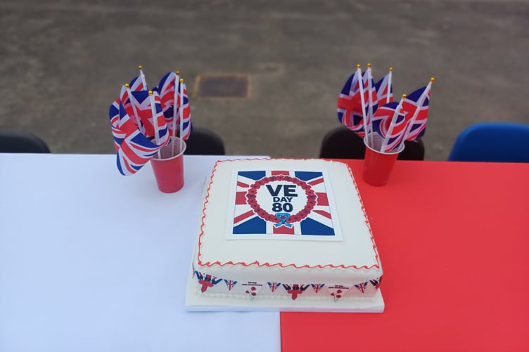 A VE Day 80th anniversary cake was baked locally for a 1940s street party for pupils of Knights Templar School, Watchet.