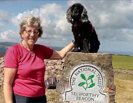Kathy Oliver and her dog Till, who is stepping down after leading walking groups from Dunster for nearly 20 years.