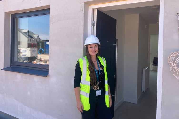 Somerset Council project officer Alex Williams outside one of the new council houses in Rainbow Way, Minehead. PHOTO: Daniel Mumby.
