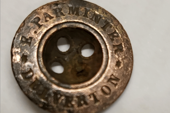 The brass button lost in the River Barle in Dulverton the 1800s and found a century later during restoration of the weir and leat. PHOTO: DWLCT.