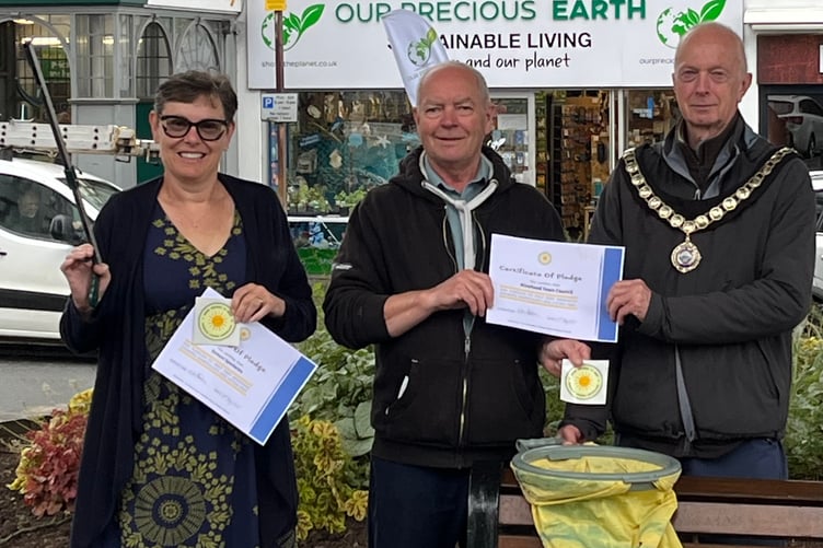 Keith Hunt presents the first 'Tidy Towns' certificates to Minehead Mayor Cllr Craig Palmer and Judith Searle owner of Exmoor Spectacles, in The Parade.