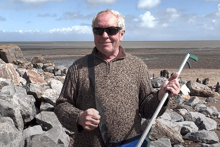 Our Precious Earth's Keith Hunt litter picking on Minehead beach.