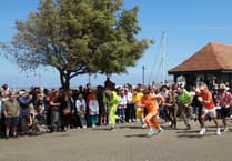 Fancy dress wheelbarrow teams race on the