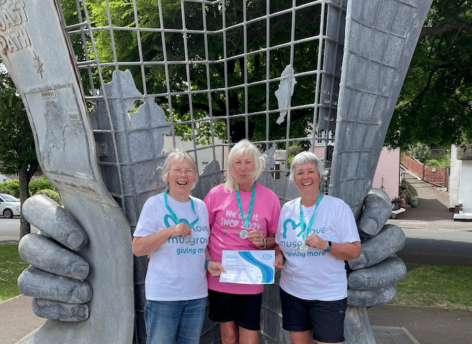 South West Coast Path walkers (left to right) Carol Matravers, Carolyn Cape,  and Hazel Binding with their medals and certificates at the path's starting point in Minehead.