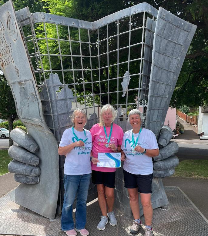 South West Coast Path walkers (left to right) Carol Matravers, Carolyn Cape, and Hazel Binding with their medals and certificates at the path's starting point in Minehead.