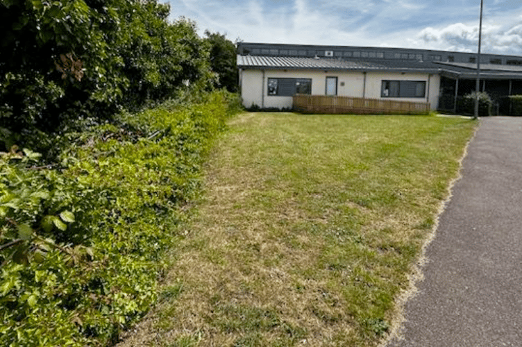 The grassed area outside Alcombe Children's Centre which Minehead town councillors are considering leasing to Cheeky Cherubs nursery. PHOTO: MTC.